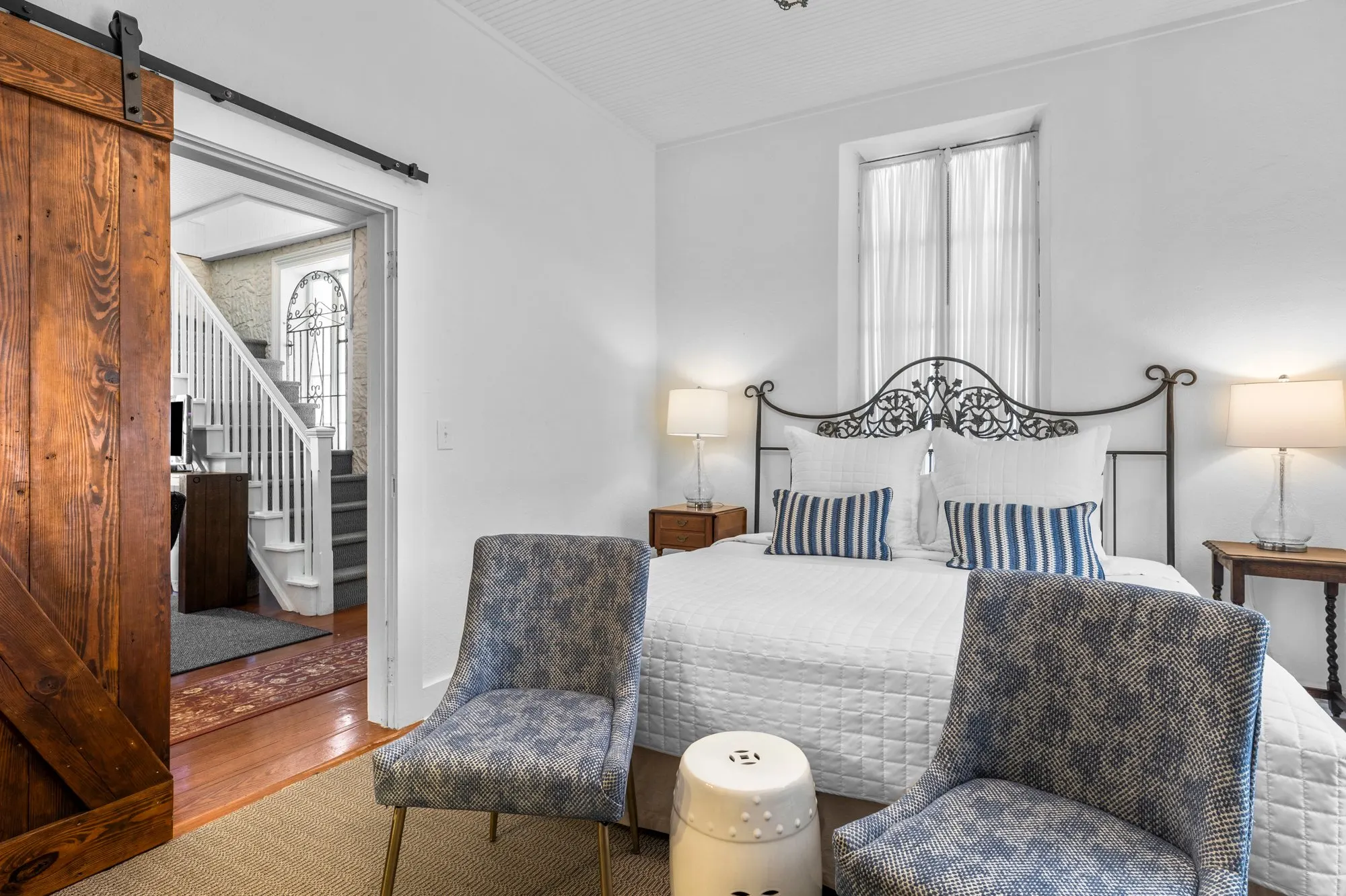 Bedroom with a sliding barn door onto the stair hall, The Meyer Hotel