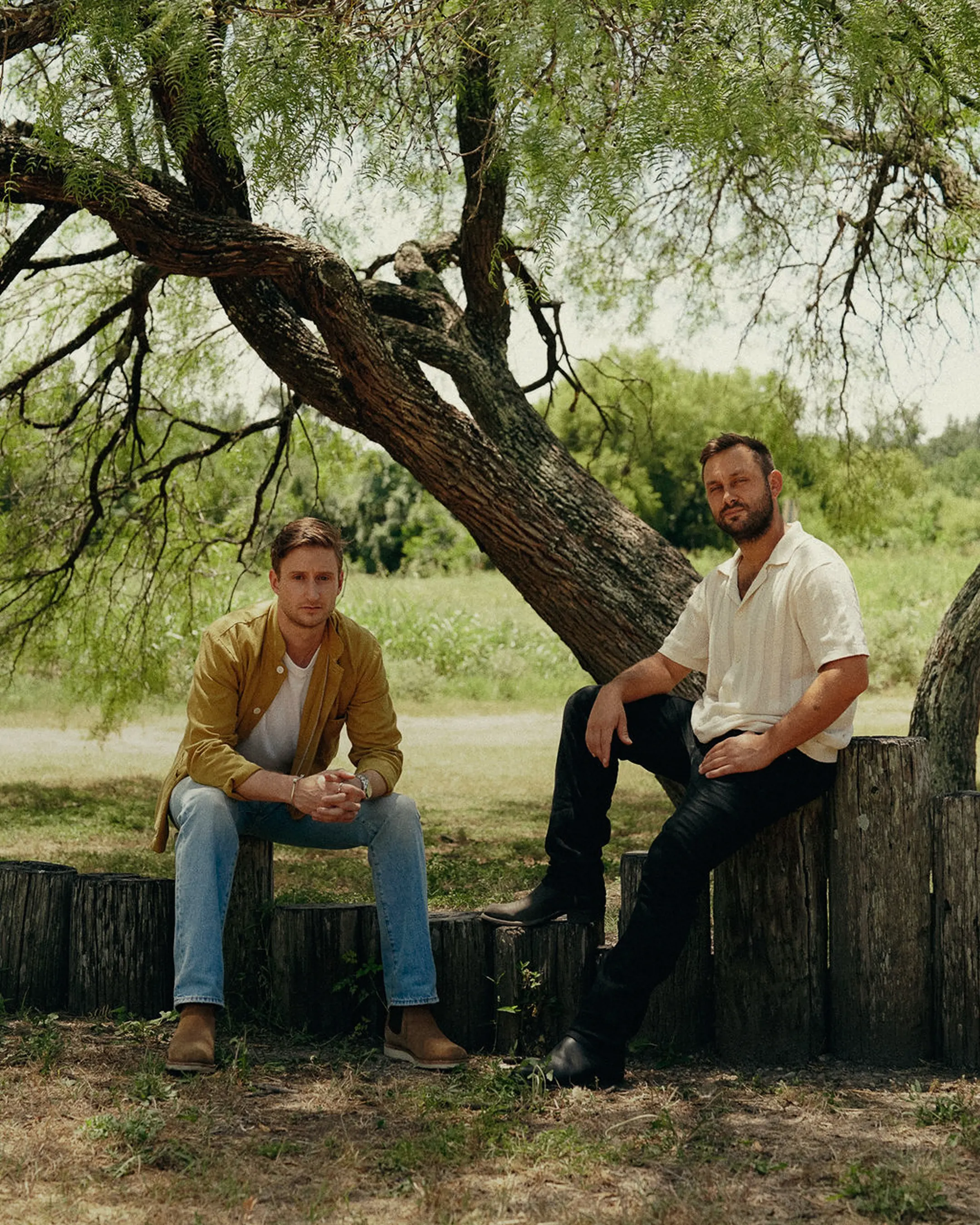 Founders Dylan and Franklin under a mesquite tree on a property