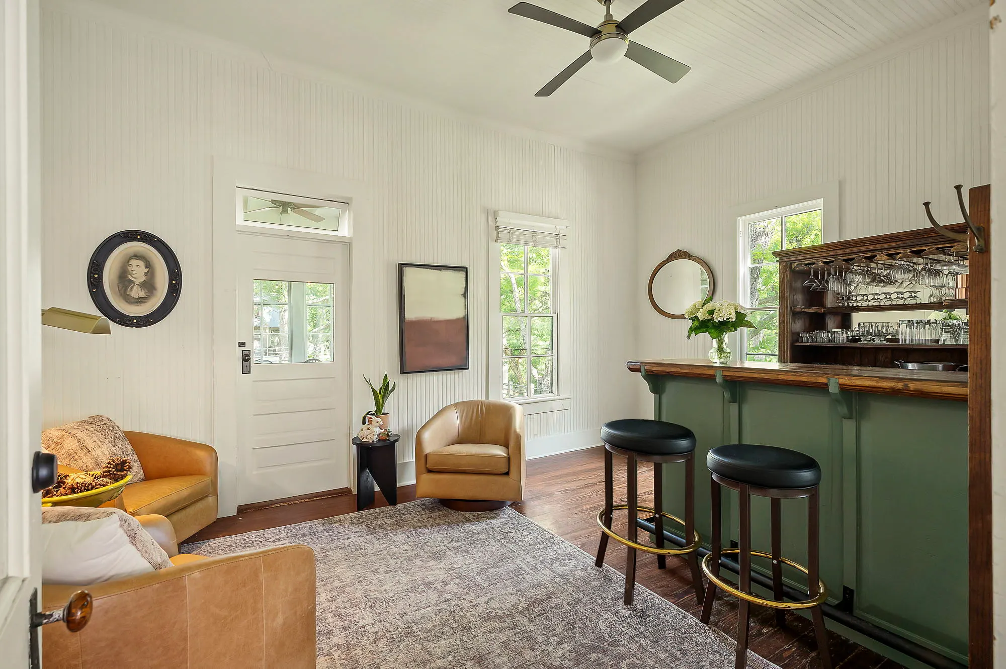 Parlor bar with a green wainscot counter, antique back bar and leather club chairs, The Meyer Hotel