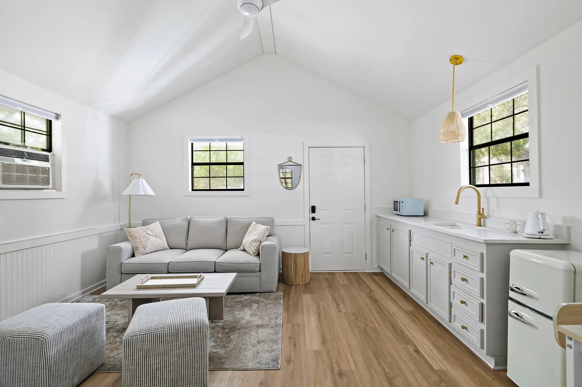Suite living area with a kitchenette and mint fridge, The Claire Hotel
