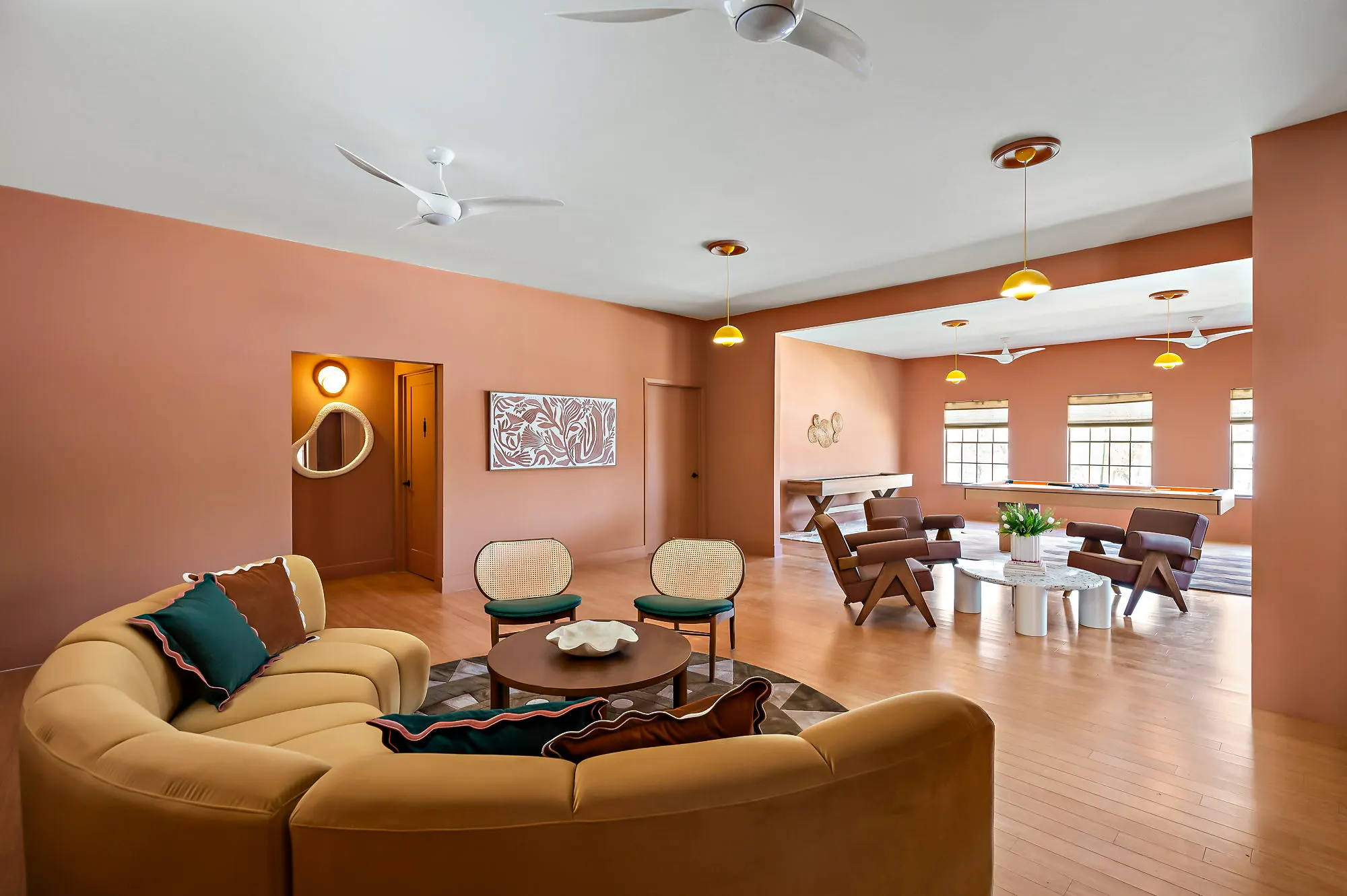 Terracotta lounge with a curved sofa, shuffleboard and pool beyond, Hacienda del Rio