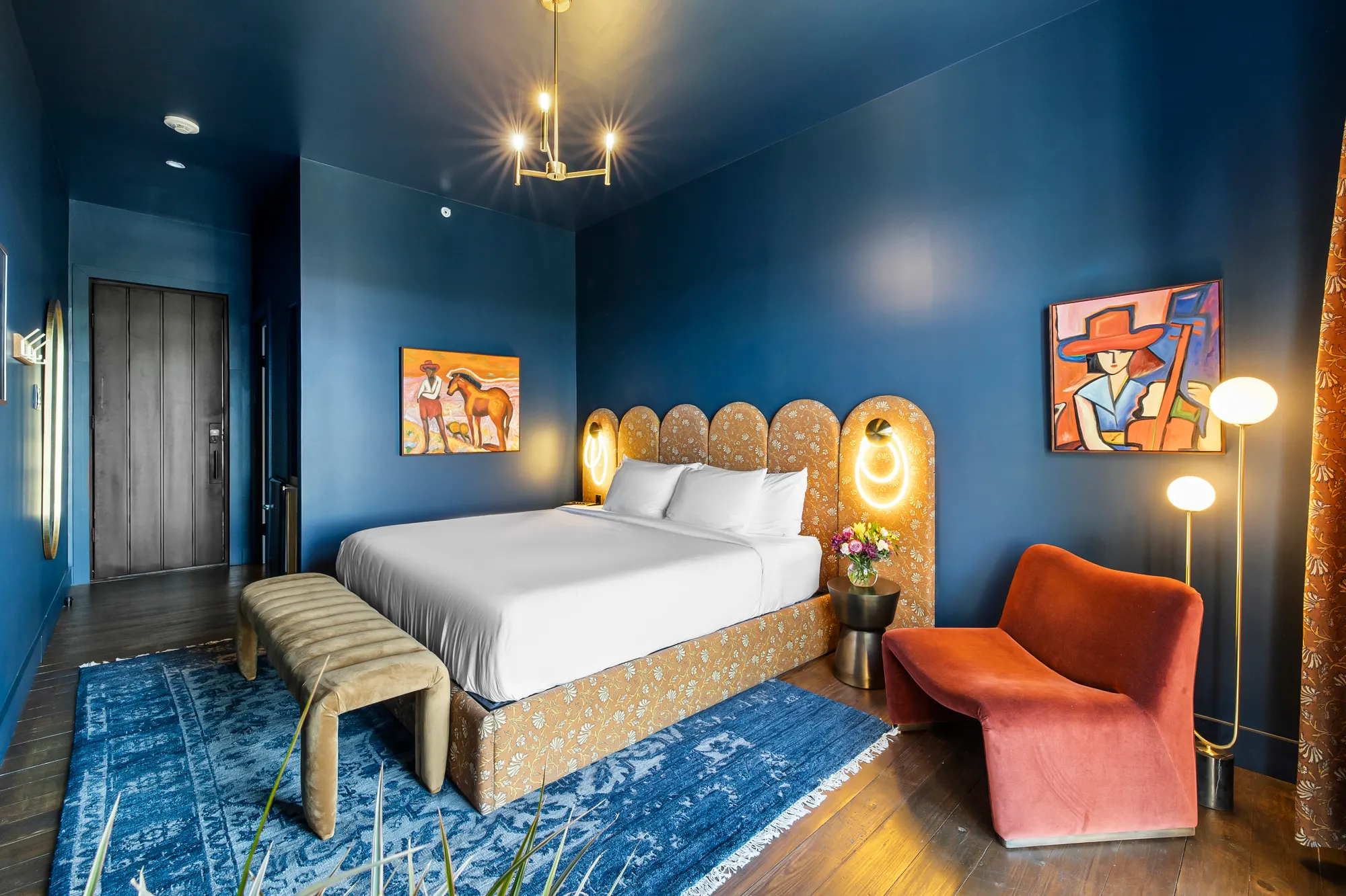 Blue guest room, wide view with velvet chair and art, Gruene River Inn