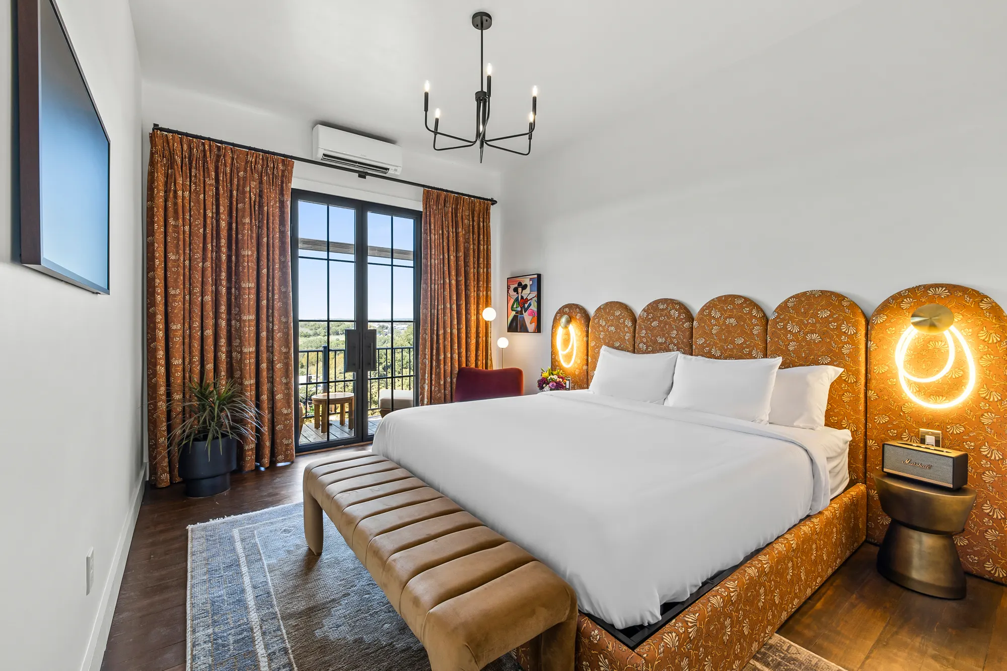 King room with rust curtains and a balcony over the Guadalupe, Gruene River Inn