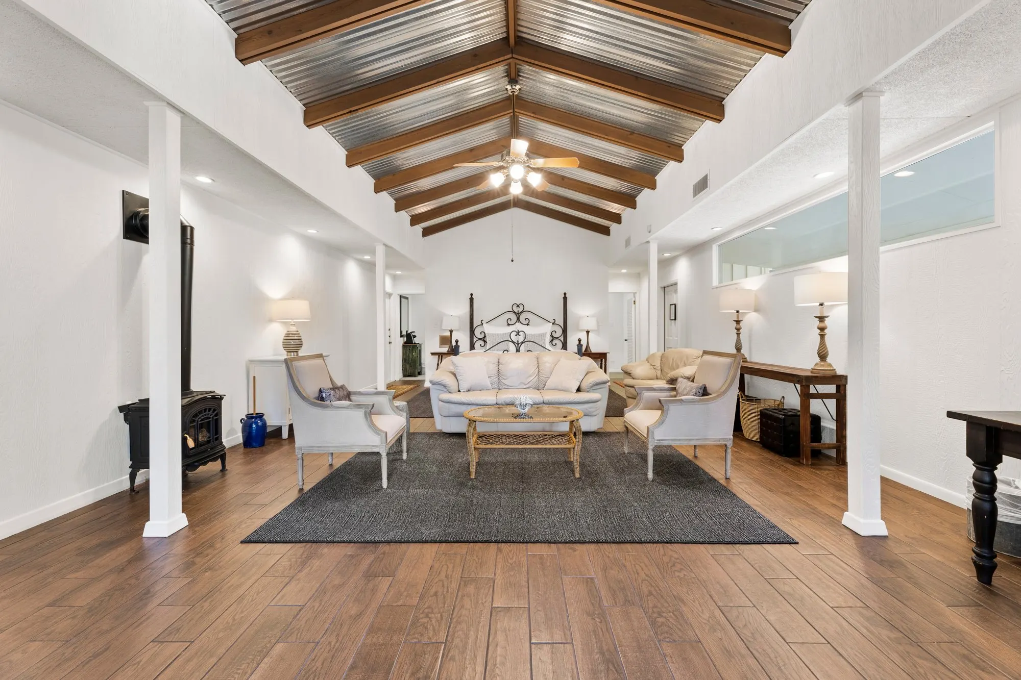 Vaulted living room with beams, tin roof and a wood stove, The Meyer Hotel