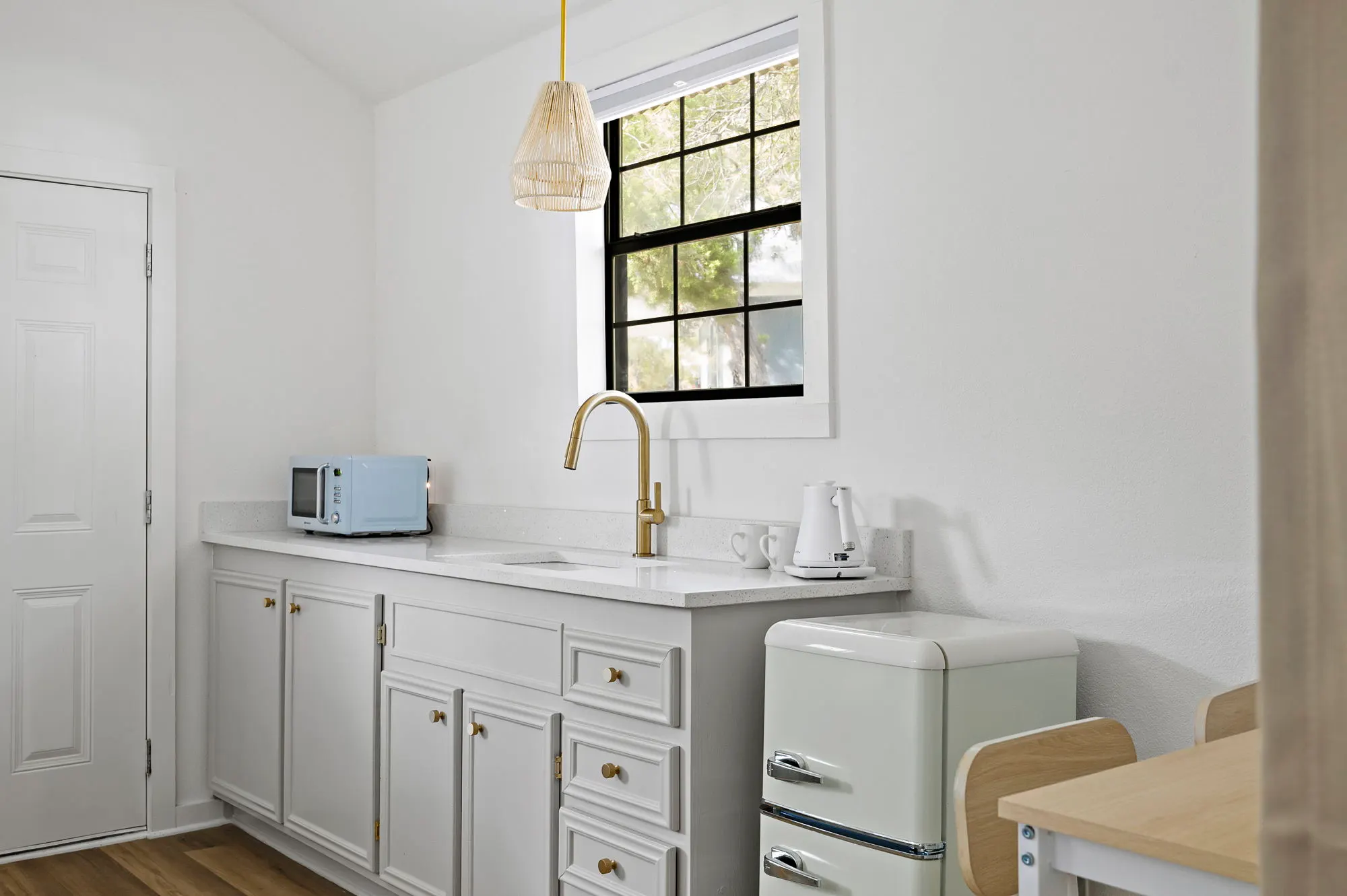 Kitchenette with a mint retro fridge and rattan pendant, The Claire Hotel